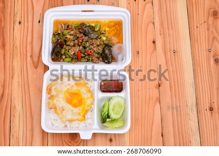 Lunch box, fried rice with pork and fried eggs,in the foam box.