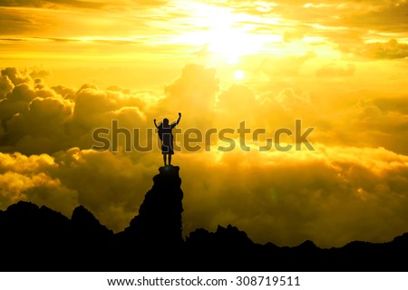 Silhouette of men backpacker open arms raised towards Standing atop the mountain over hope sky at sunset light effect ,Concept for life achievements and success concept