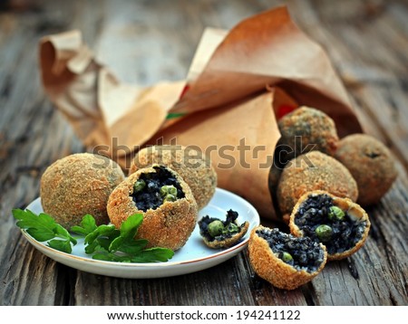 Deep fried black rice balls  with cuttlefish ink and green peas
