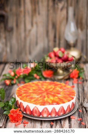 Fancy cake with strawberries on the wooden table