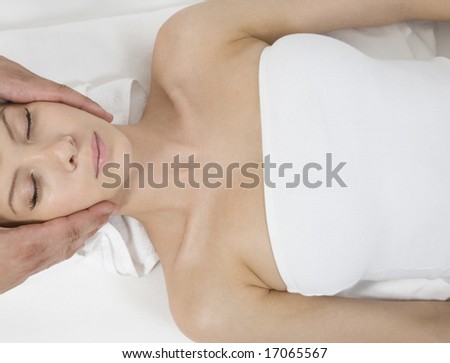 woman getting a head rub on isolated background