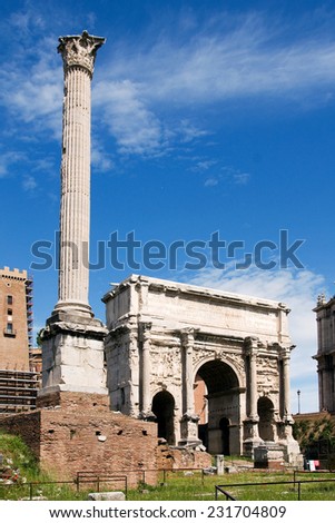 ROME, ITALY, MAY 09, 2012 - Triumphal Arch of Titus in the Roman Forum with tall column and head