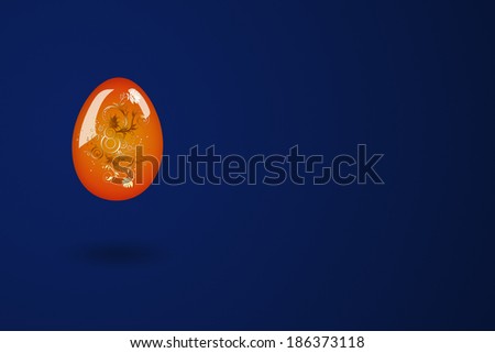 Easter egg in red and yellow, on a blue background. Included clipping path