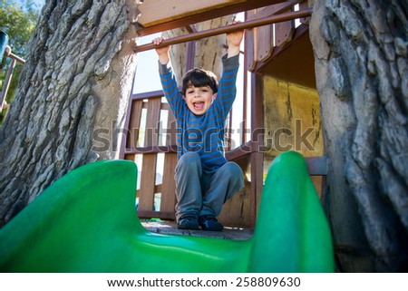 Kid plays outside in the playground