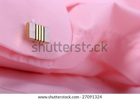 Close-up of cufflink on pink shirt 1