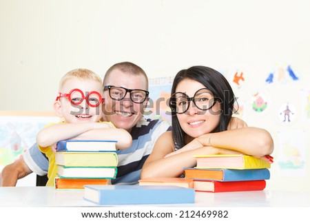 Family with glasses and many books.