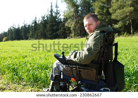 Military soldiers being wounded was in a wheelchair.