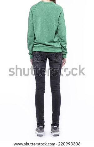 back Side view of a standing woman(female) model wearing black denim(trousers) with Green top isolated on a white background