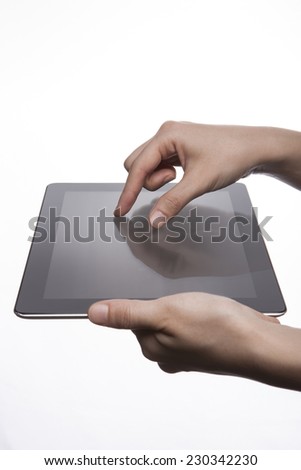 A female(woman, girl) hand support tablet pc device and finger touch(expanding) the screen isolated white at the studio.