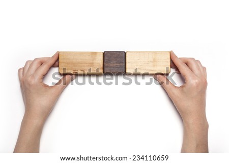 A female hand hold(pick up) the various wood blocks isolated white, top view at the studio.