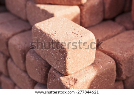 Red bricks be stacked(be heaped, pile up) up make background at the daylight in the morning.