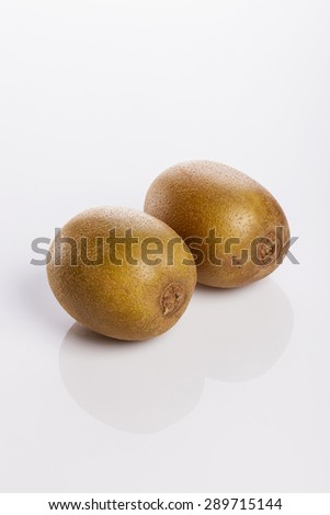Two gold kiwi isolated white reflected at the studio.