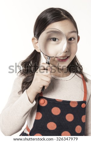A asian(japan, chinese, korea) pretty girl hold a reading glasses(magnifying glass[lens], magnifier) and watch the something with smile isolated white at the studio.