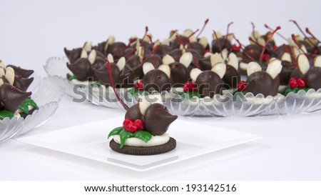 Home made Holiday Chocolate Candy Mice on a cookie with frosting holly leaves and berries