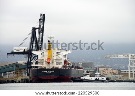 OAKLAND, CA - SEPTEMBER 19, 2014: Ultra Dynamic Bulk Carrier ship docked at the Port of Oakland. Belships Management (Singapore) Pte Ltd is listed as the owner of this vessel.