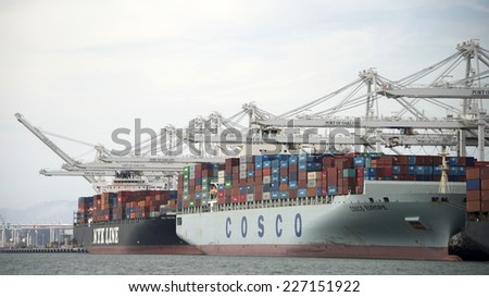 OAKLAND, CA - OCTOBER 30, 2014: Cosco Container lines provides world wide shipping services year round. Nippon Yusen Kabushiki Kaisha or NYK Line, one of the largest shipping companies in the world.
