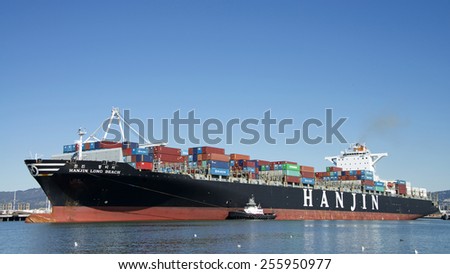 OAKLAND, CA - FEBRUARY 24, 2015: Hanjin Cargo Ship LONG BEACH entering the Port of Oakland. Hanjin is a large South Korean shipping company operating cargo vessels of all types all over the world.