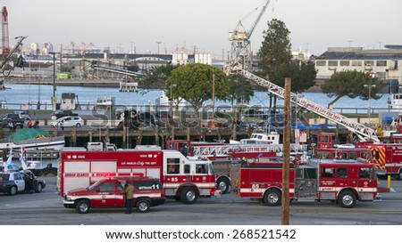 SAN PEDRO, CA - APRIL 09, 2015: Rescue operations underway as the sun goes down at the Port of Los Angeles where a vehicle with a family inside veered off the dock into the water at Berth 73.