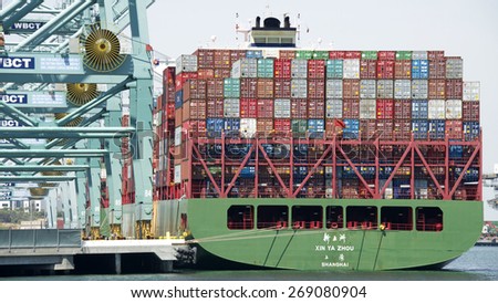 SAN PEDRO, CA - APRIL 10, 2015: China Shipping Ship XIN YA ZHOU loading at the Port of Los Angeles. The Port of LA is located in the San Pedro Bay, is the busiest container port in the United States.
