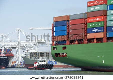 OAKLAND, CA - MAY 03, 2015: China Shipping Lines Cargo Ship CSCL SPRING entering the Port of Oakland with Tugboat VALOR assisting from the stern