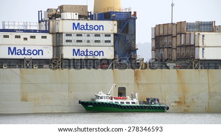OAKLAND, CA - MAY 05, 2015: Passenger Vessel LANA at the Port side door of Matson Cargo Ship MANOA, docked at the Port of Oakland.