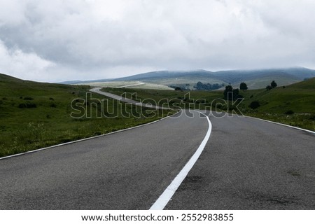 Similar – Image, Stock Photo Winding road on hilly terrain