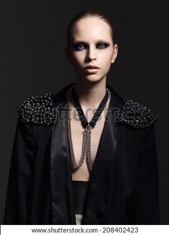 model in studio dressed in black on a black background
