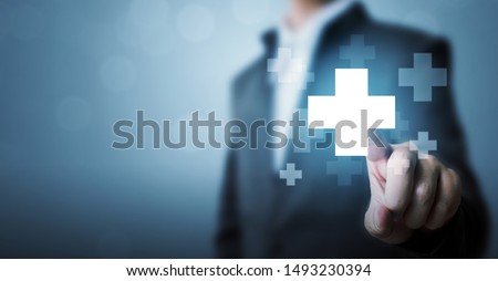 Businessman hand touching plus sign icon means to offer positive thing (like benefits, personal development, social network) Foto stock © 