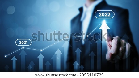 Businessman pointing arrow graph corporate future growth plan. Business development to success and growing growth year 2021 to 2022 concept