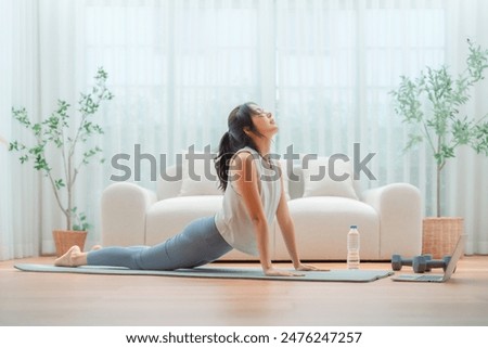 Image, Stock Photo Young woman stretching and breathing fresh air in middle of forest while exercising