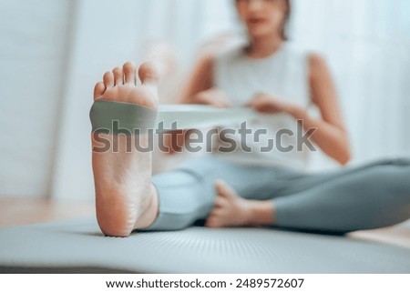 Similar – Image, Stock Photo Woman with resistance band on wrists working out at home