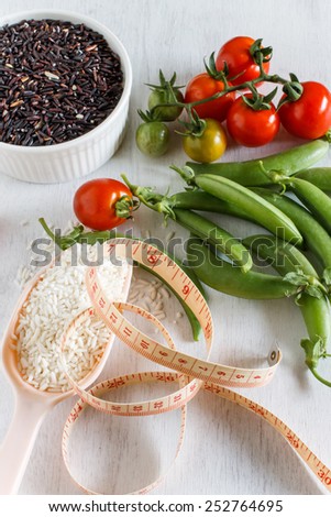 Abstract fresh organic vegetables with rice on white wooden. Food background. Healthy food from garden