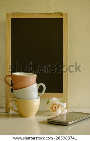 Colorful Coffee Cup , Blackboard , Flower , Smart Phone In Vintage Cross Process Color Tone : Selective Focus. Image Of Coffee Lover Soft Tone. Object Pastel.