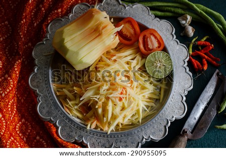 Local authentic cuisine of southeast asia: ingredients set of papaya salad or Som Tum in Thai name. Popular food of Thailand with Isan cloth background.