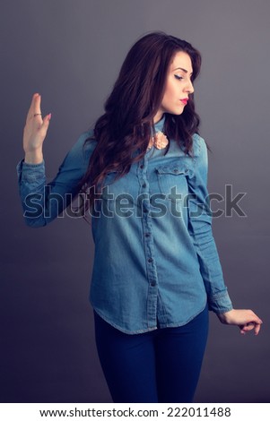 Girl making talk to the hand gesture being indifferent