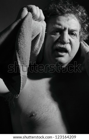 middle-aged man with a towel out of the bathroom