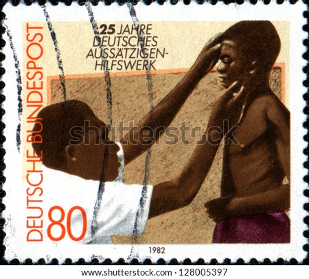 GERMANY - CIRCA 1977: A stamp printed in German Federal Republic dedicated to year German aid to lepers, shows doctor examines a patient, circa 1977