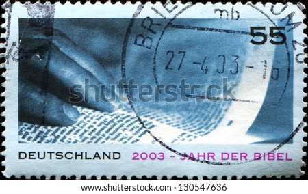 GERMANY - CIRCA 2003: A stamp printed in German Federal Republic issued for Year of the Bible,  showsHand and Page, circa 2003