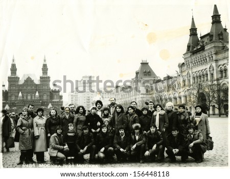 MOSCOW - CIRCA 1984: A group of tourists in Red Square against Vladimir Lenin Museum, now the Historical Museum and the GUM, Moscow, USSR, 1984