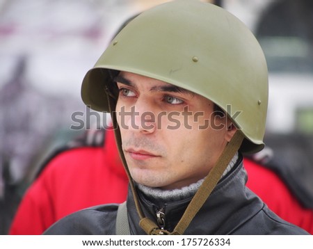 UKRAINE, LUGANS - FEBRUARY 9, 2013: One of the organizers of the rally in the Soviet military helmet World War II.  Rally in support of Berkut no more than 30-40 people.