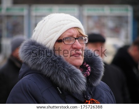 UKRAINE, LUGANS - FEBRUARY 9, 2013: Woman is a rally participant. Organized under the flags of Russia and Ukrainian SSR defunct rally in support of special forces Berkut gathered about 30-40 people.