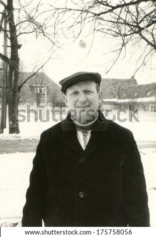 GERMANY, LEIPZIG - CIRCA 1960s: An antique photo of man posing on a snowy street