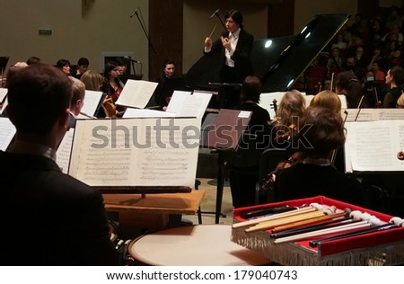 UKRAINE, LUGANSK - FEBRUARY 27,  2014: Lugansk Philharmonic Orchestra performed the Concerto No1 for piano and orchestra by Camille Saint-Saens. Conductor is Catherine Osadchaya, soloist - Irina Burgan.