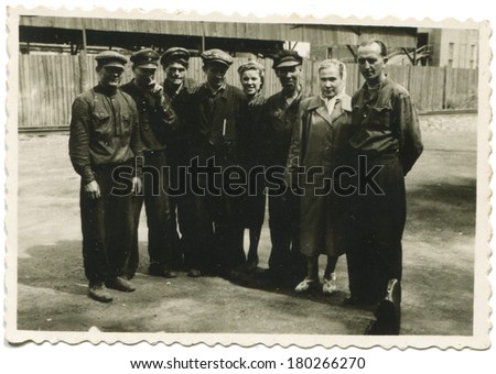 ESTONIA, VALGA - CIRCA 1950: An antique photo of group of workers in the factory yard