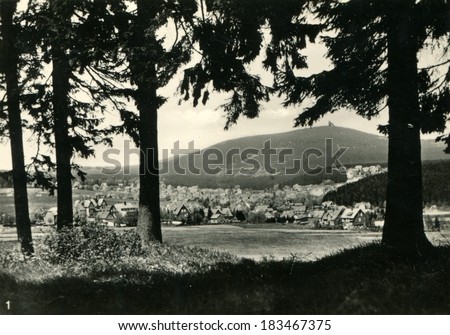 GERMANY - CIRCA 1950s: An antique photo shows houses on a background of mountains