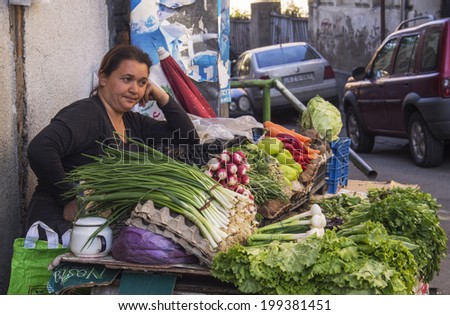 TBILISI, GEORGIA - April 30, 2014: Woman seller of vegetables. Farmer market in old town Sololaki, Tbilisi. Suitable for farming areas account only for 16% of the total territory of the country.