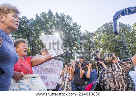 UKRAINE, KYIV - Sep 1, 2014: Weeping soldiers\' mothers blocking the bus with the artists. -- Mother fighters 51th Volyn teams that require their children to return from captivity.