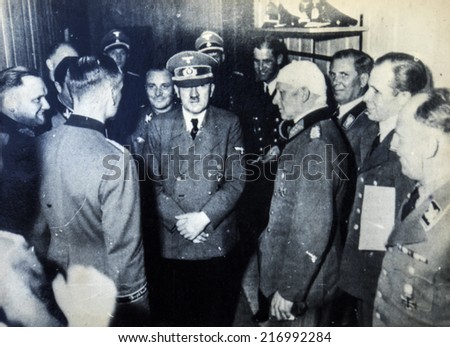 GERMANY - CIRCA 1940s: Adolf Hitler among the officers, one of whom is bandaged head. Reproduction of antique photo.