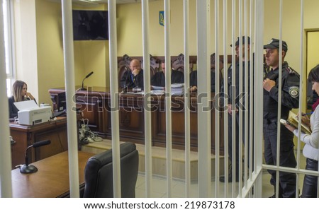 UKRAINE, KYIV - September 26, 2014: Judicial board on case of Dmitry Sadovnik through bars of cage for defendant. Court of Appeal set aside appeal prosecution in a criminal case against the Sadovnik