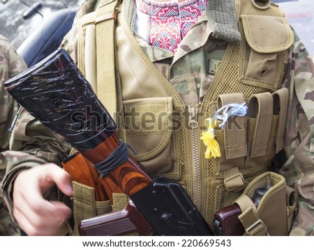 UKRAINE, KYIV - September 30, 2014: Children tied for soldiers yellow blue charms in the form of angels. -- From Kiev to the war zone went advance party of the battalion of special purpose 